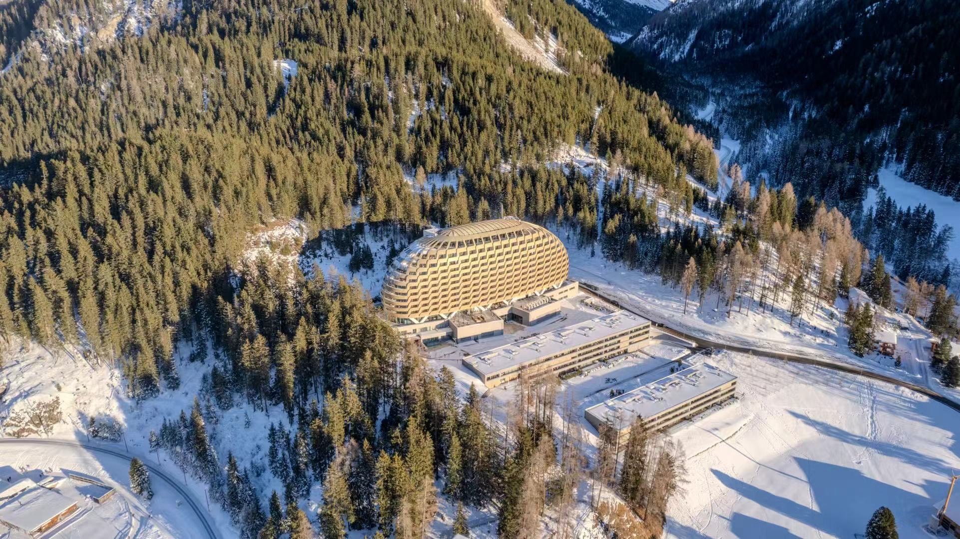 Aerial view of the WEF Congress Centre in Davos surrounded by alpine forest